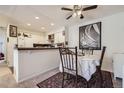 Bright condo dining area with modern fixtures, seamlessly connected to the adjacent kitchen space at 4480 S Pitkin St # 128, Aurora, CO 80015