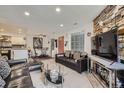 Inviting condo living area seamlessly blends with dining and kitchen, featuring a stone fireplace at 4480 S Pitkin St # 128, Aurora, CO 80015