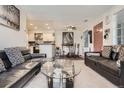 Open-concept condo living and dining area featuring stylish decor, perfect for modern living at 4480 S Pitkin St # 128, Aurora, CO 80015