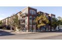 Attractive exterior view of an apartment building with balconies, windows and mature trees at 1489 Steele St # 104, Denver, CO 80206