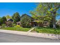 Charming two-story home with lush lawn, mature trees, and professional landscaping at 5755 S Fulton Way, Greenwood Village, CO 80111