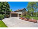 Well-maintained home with lush lawn, long driveway, and three car garage at 5755 S Fulton Way, Greenwood Village, CO 80111