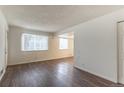 A view of the living room showcasing an open floor plan with hardwood floors and lots of light at 13393 E Louisiana Ave, Aurora, CO 80012