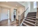 Welcoming foyer with hardwood floors, staircase, and plenty of natural light streaming through the front door at 935 Peach Leaf Ln, Elizabeth, CO 80107