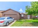 Charming single-Gathering home with an attached garage and mature shade tree at 11599 Kendall St, Westminster, CO 80020