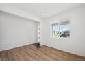 Bright entryway with wood floors, white walls, large window and a modern front door at 1331 Rock Cliff Ave, Erie, CO 80516