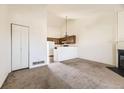 Open floor plan featuring carpeted floors, a fireplace, and kitchen view at 1100 S Waco St # D, Aurora, CO 80017