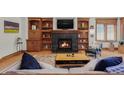 Inviting living room featuring a fireplace, built-in bookshelves and hardwood floors at 1143 S Saint Paul St, Denver, CO 80210