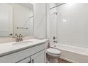 Spotless bathroom features a shower and tub combination, a brushed nickel faucet and all white tiling at 39161 Anthony St, Elizabeth, CO 80107