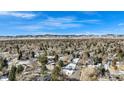 Panoramic aerial view showcasing neighborhood homes with mountain views on a clear day at 5121 W Plymouth Dr, Littleton, CO 80128