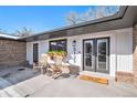 Welcoming front porch with rocking chairs, a decorative planter, and double doors at 5121 at 5121 W Plymouth Dr, Littleton, CO 80128