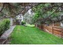 Spacious, grassy backyard with a wooden fence, offering privacy and room for outdoor activities at 4621 S Fraser Cir # A, Aurora, CO 80015