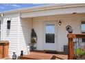 Close up of the front porch with seating area and potted plants at 11299 E 159Th Pl, Brighton, CO 80602
