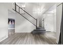 Open entryway with staircase, wood flooring, and natural light, creating a welcoming atmosphere at 2691 E 132Nd Ave, Thornton, CO 80241