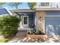 Inviting front porch with a cozy bench, decorative planter, and a well-maintained garden bed at 2691 E 132Nd Ave, Thornton, CO 80241
