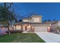 Beautiful home with a manicured lawn and a welcoming entrance, perfect for a growing Gathering at 7454 Snow Lily Pl, Castle Pines, CO 80108