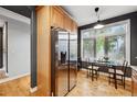 Cozy dining area adjacent to the kitchen with a stainless steel refrigerator at 2319 Decatur St, Denver, CO 80211