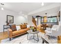 Open-concept living room with hardwood floors seamlessly connected to dining at 2319 Decatur St, Denver, CO 80211