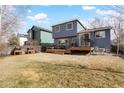 Spacious backyard with a wooden deck and well-maintained lawn at 17623 Cornish Pl, Parker, CO 80134