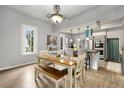 Eat-in kitchen with a wooden dining table, breakfast bar, stainless steel appliances, and natural light at 805 5Th St, Fort Lupton, CO 80621