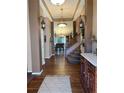 Spacious foyer showcasing hardwood floors and decorative sconces at 17046 Wellington Dr, Parker, CO 80134