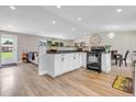 Eat-in kitchen featuring white cabinets and black appliances. Includes seating at 6441 W 73Rd Pl, Arvada, CO 80003