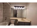 Updated bathroom featuring stylish fixtures, a new toilet, and modern tile work at 1818 S Quebec Way # 5-7, Denver, CO 80231