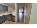Modern kitchen with new stainless steel appliances and wood floor at 1818 S Quebec Way # 5-7, Denver, CO 80231