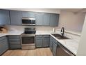 Updated kitchen with stainless steel appliances, modern countertops, and ample cabinet space at 1818 S Quebec Way # 5-7, Denver, CO 80231
