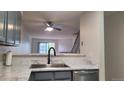Modern kitchen featuring a stainless steel sink, elegant gray cabinets, and sleek countertops at 1818 S Quebec Way # 5-7, Denver, CO 80231