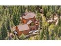 Beautiful mountain home features an attached two-car garage, a guest house, and multiple decks at 4618 Se Summit Trl, Evergreen, CO 80439