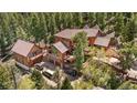Large mountain home has an attached garage, a guest house, and a wrap-around deck at 4618 Se Summit Trl, Evergreen, CO 80439