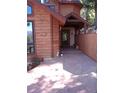 Inviting front entrance with a covered porch, stone walkway, and cozy bench seating at 4618 Se Summit Trl, Evergreen, CO 80439