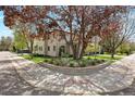 Landscaped corner lot featuring a beautiful mature tree and manicured lawn at 2500 S Monroe St, Denver, CO 80210