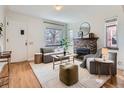 Cozy living room with a decorative fireplace and lots of natural light at 3921 N Raleigh St, Denver, CO 80212