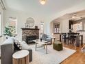 Bright living room with fireplace and views to dining and kitchen at 3921 N Raleigh St, Denver, CO 80212