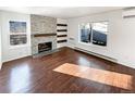 Bright living room with hardwood floors and a fireplace at 2500 S Victor St # A, Aurora, CO 80014