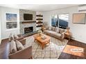 Virtually staged living room featuring a fireplace and hardwood floors at 2500 S Victor St # A, Aurora, CO 80014