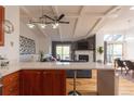 Bright living space with a modern ceiling fan, a cozy fireplace, and an open floor plan at 20600 Rangeview Dr, Morrison, CO 80465