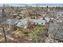Aerial view of the home in a residential neighborhood, showcasing the yard and mature trees at 1824 S Logan St, Denver, CO 80210
