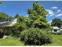 Charming home with decorative shingles and lush foliage surrounding the entrance at 1824 S Logan St, Denver, CO 80210
