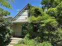 Charming home with decorative shingles and lush foliage surrounding the entrance at 1824 S Logan St, Denver, CO 80210