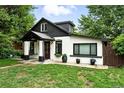 Quaint exterior of a home with freshly cut lawn and covered porch with a swing at 4968 Alcott St, Denver, CO 80221