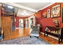 Spacious living room with hardwood floors, art display and adjacent staircase at 4968 Alcott St, Denver, CO 80221