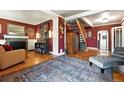 Inviting living room featuring hardwood floors, fireplace, and striking accent wall at 4968 Alcott St, Denver, CO 80221