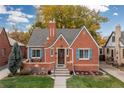 Charming brick house with blue shutters at 1545 Newport St, Denver, CO 80220