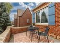 Small patio with brick wall and seating at 1545 Newport St, Denver, CO 80220