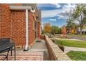 Brick home with side patio and street view at 1545 Newport St, Denver, CO 80220