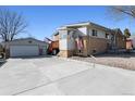 Spacious backyard with a detached garage, back patio, and additional parking for a boat or RV at 6409 Brentwood St, Arvada, CO 80004