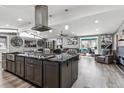 Open concept kitchen and living area with a large island, stainless steel appliances, and modern finishes at 6409 Brentwood St, Arvada, CO 80004